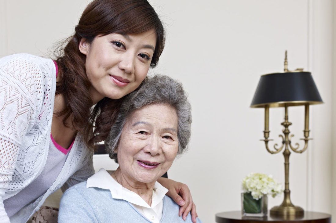 senior asian woman and her nursing care service provider