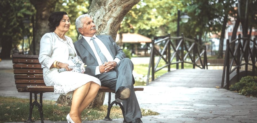 a couple of elderly enjoy their life and having a rest in a park